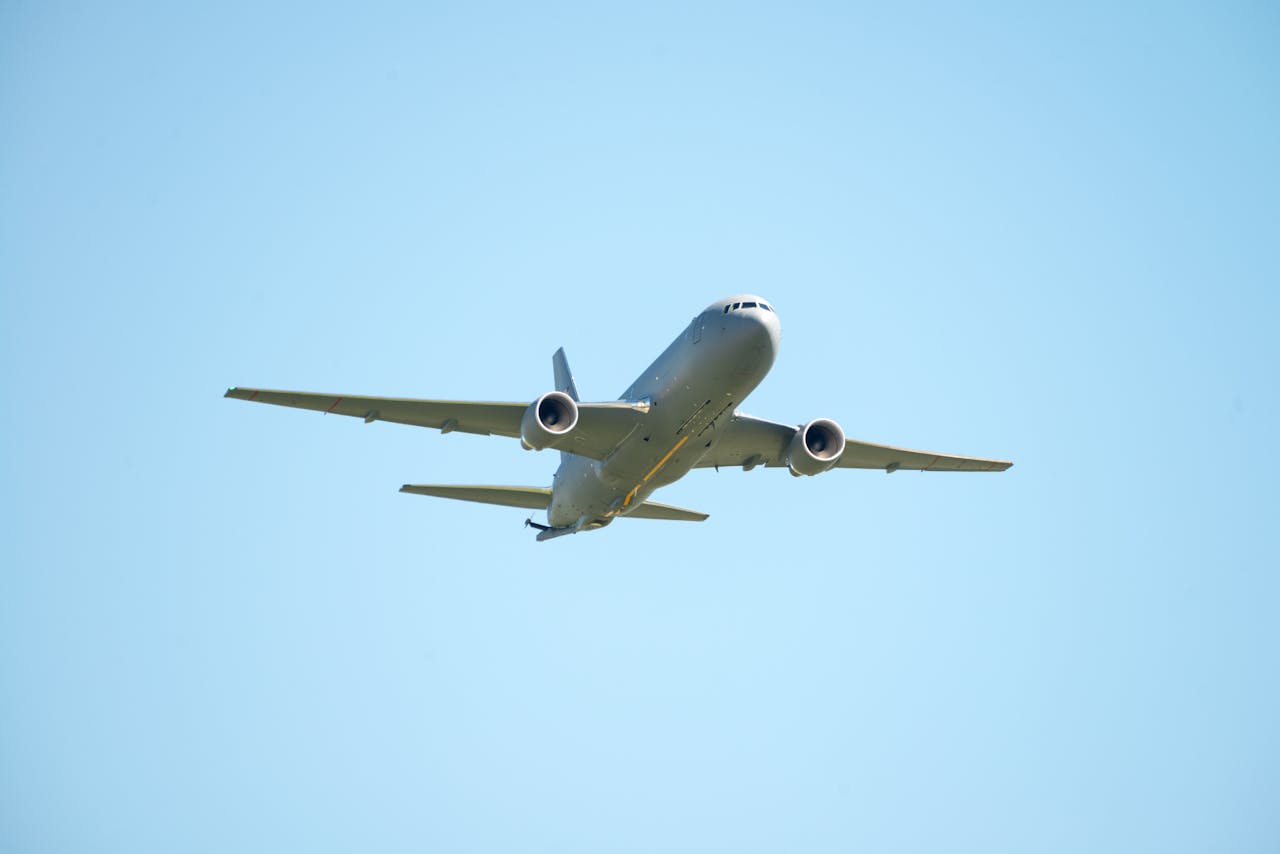Large aircraft soaring gracefully in the clear blue sky over Fairfield, California.